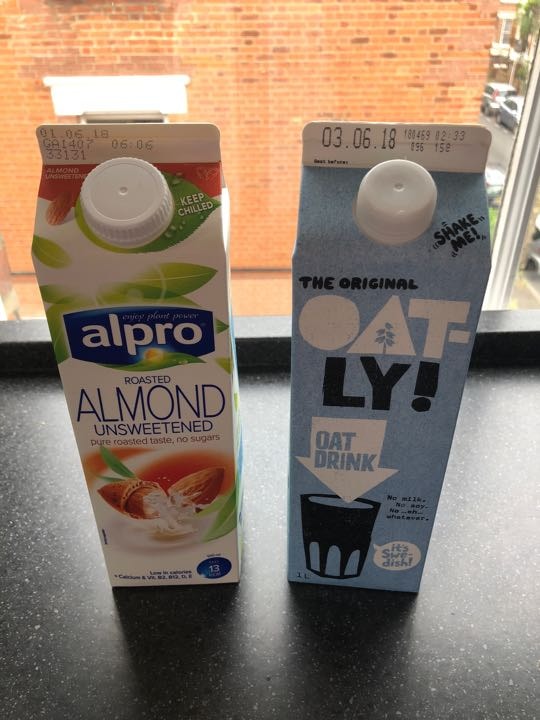Alpro unsweetened roasted almond drink and Oatly original oat drink OLIO